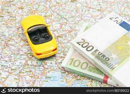 money and yellow car on map of Europe closeup