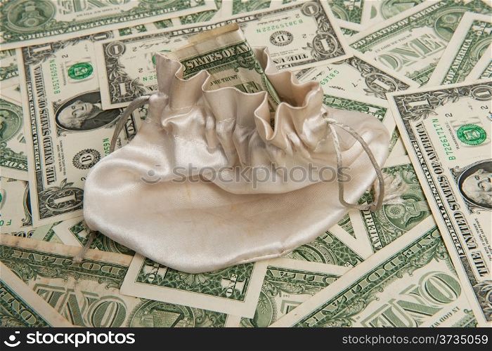 Money bag on paper money dollar pile