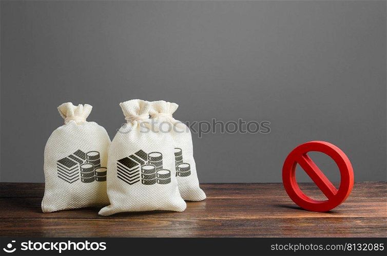 Money bags and red prohibition sign no. Restrictions on the export of capital, Economic pressure and sanctions. Lack of investment and inflow of finance. Regulatory laws in the financial sector.