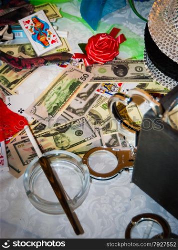 Money, cards, handcuffs and an ashtray