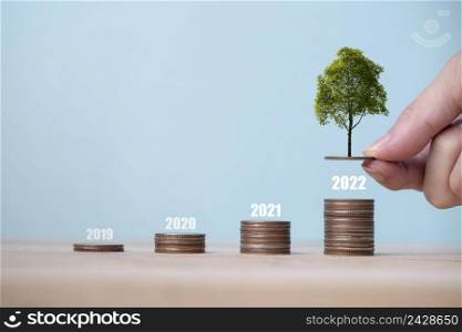 Money coin stack growing graph and a tree that grows on a pile of money, The idea of business finance and saving money investment and Growing Money, Tree growing up on coins