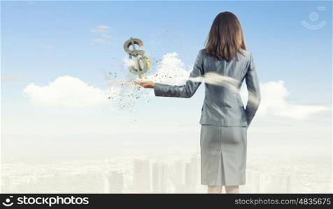 Money concept. Back view of businesswoman holding money symbol in palm