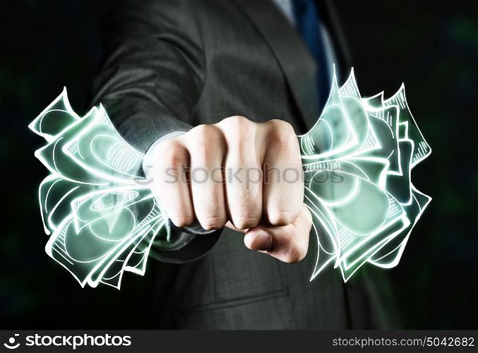 Money concept. Close up of businessman hand clenching money banknotes in fist