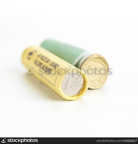 Money concept. Rolls of Euro coins on white