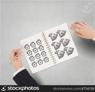 Money earning instruments. Businessman hands drawing money making formula in notepad