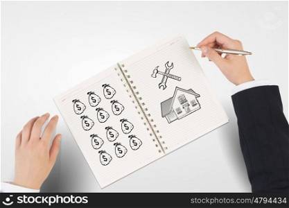 Money earning instruments. Businessman hands drawing money making formula in notepad