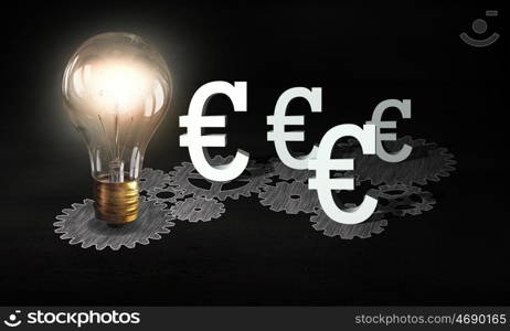 Money earning machine. Gears mechanism and glowing light bulb on dark background