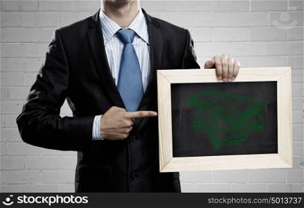 Money earning . Unrecognizable businessman holding blackboard with drawn money concept