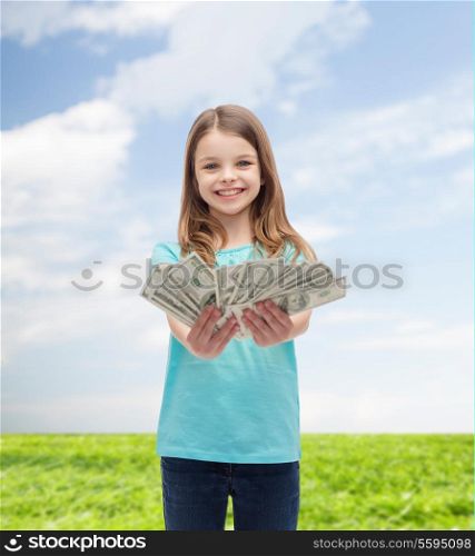 money, finances and people concept - smiling little girl giving dollar cash money