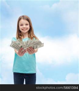 money, finances and people concept - smiling little girl giving dollar cash money