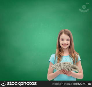 money, finances and people concept - smiling little girl with dollar cash money