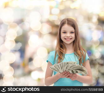 money, finances and people concept - smiling little girl with dollar cash money