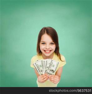 money, finances and people concept - smiling little girl with dollar cash money