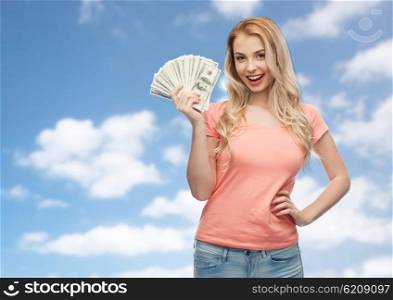 money, finances, investment, saving and people concept - happy young woman with dollar cash money over blue sky and clouds background