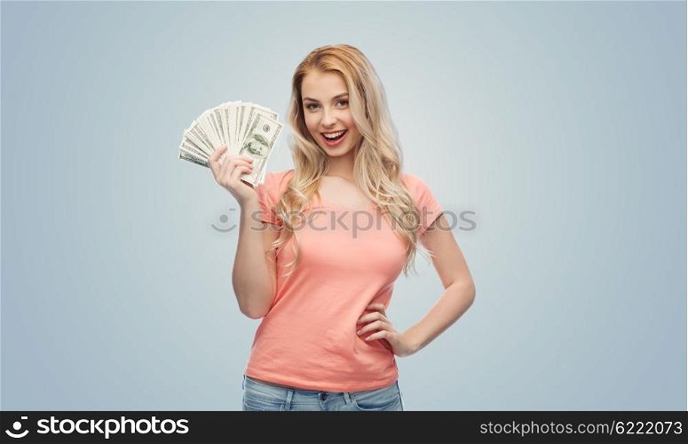 money, finances, investment, saving and people concept - happy young woman with dollar cash money over gray background