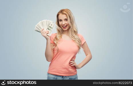 money, finances, investment, saving and people concept - happy young woman with dollar cash money over gray background