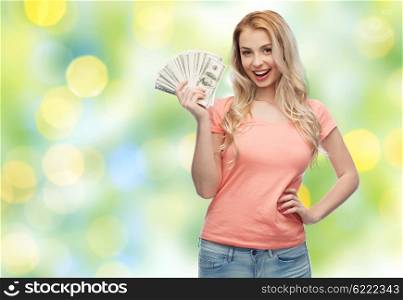 money, finances, investment, saving and people concept - happy young woman with dollar cash money over summer green lights background