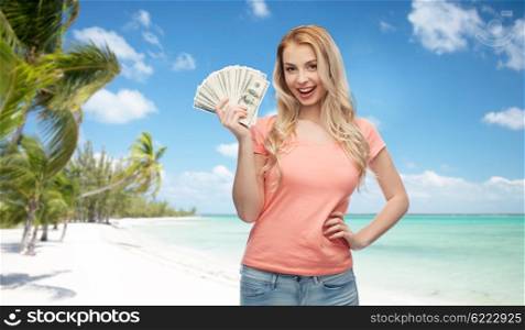money, finances, travel, tourism and people concept - happy young woman with dollar cash money over exotic tropical beach with palm trees background