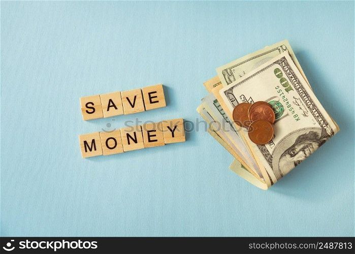 Money in international currency, dollars, euro coins lie on a blue background. Lettering save money. Money in international currency, dollars, euro coins lie on a blue background. Lettering save money.