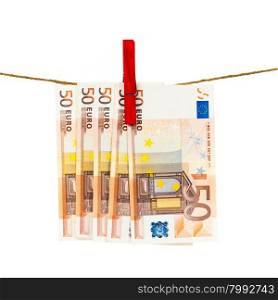Money laundering on clothesline isolated on white background. Euro banknotes hanging