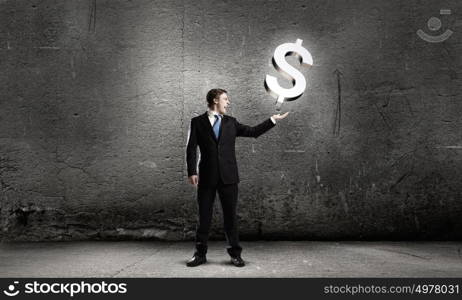 Money making. Businessman in suit holding dollar sign in palm