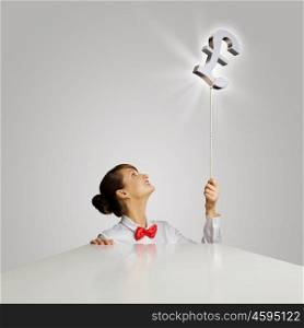 Money making. Young woman holding balloon shaped like pound sign