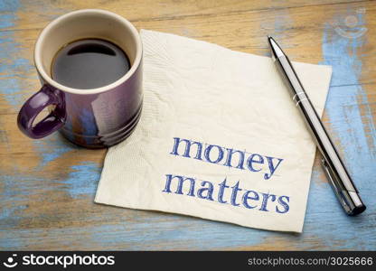 money matters note - handwriting on a napkin with a cup of espresso coffee