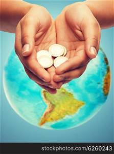 money, people, economy, charity environmental protection and finances concept - close up of woman cupped hands holding euro coins and blue background