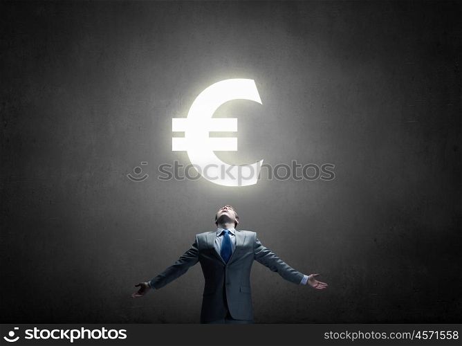 Money power. Businessman with hands spread apart and euro sign above