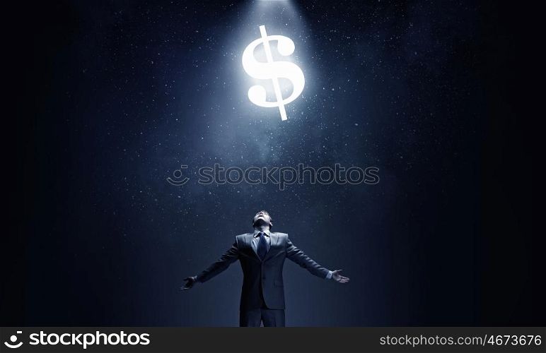 Money power. Businessman with hands spread apart and money sign above