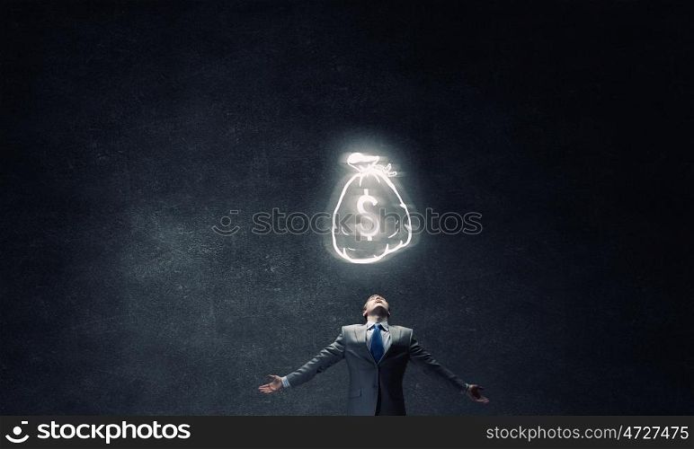Money power. Businessman with hands spread apart and money sign above