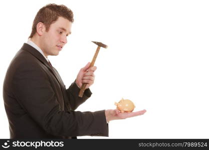 money saving concept. business man guy with hammer about to smash piggy bank isolated on white