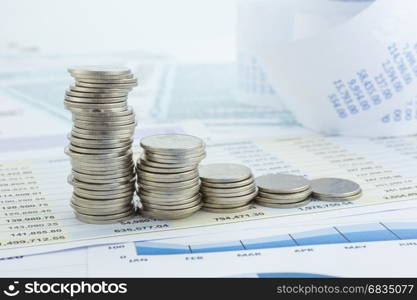 Money symbol in curve. stacks of silver coins put on business financial statements and graphs.