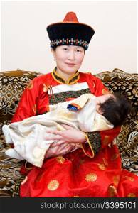 Mongolian woman holds her baby