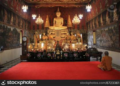 Monk and Buddha in Wat Suwandararam Rajawaraviharn