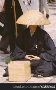 Monk begging at the sidewalk, Tokyo Prefecture, Japan