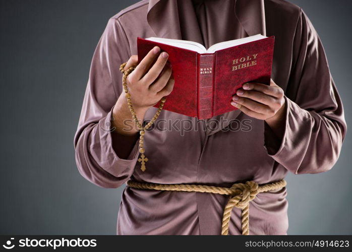 Monk in religious concept on gray background