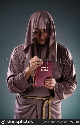 Monk in religious concept on gray background