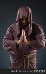 Monk in religious concept on gray background