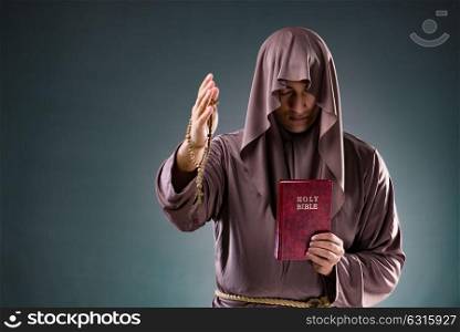 Monk in religious concept on gray background