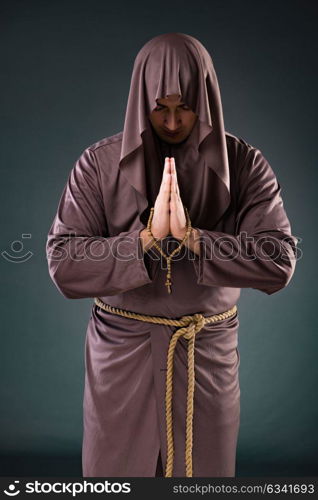 Monk in religious concept on gray background