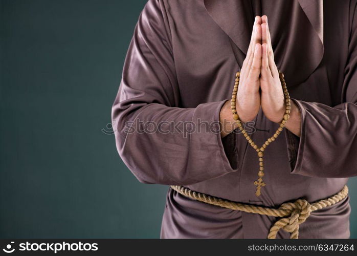 Monk in religious concept on gray background