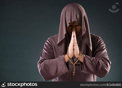 Monk in religious concept on gray background