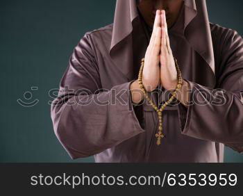 Monk in religious concept on gray background