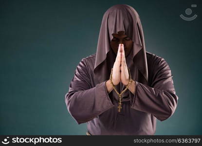 Monk in religious concept on gray background