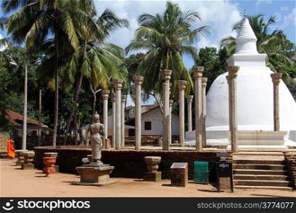 Monk, statue and Ambasthala dagaba in Mihintale, Sri Lanka