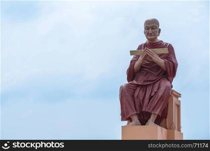monk statue of buddhist recite scriptures