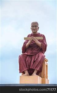 monk statue of buddhist recite scriptures