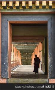 Monk walking in corridor, Punakha Dzong, Punakha, Punakha Valley, Punakha District, Bhutan