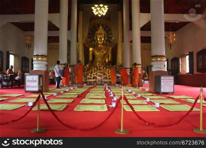 Monks on the red carpet in wat Phra Singh in Chiang Mai, Thailand